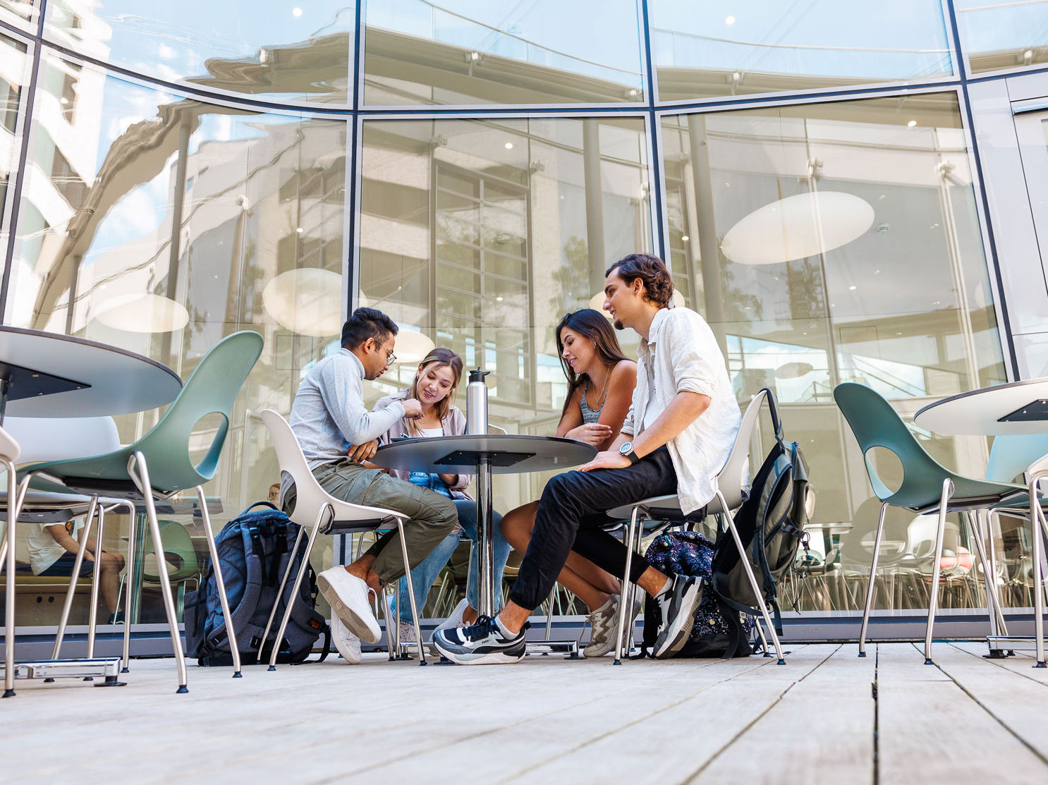 Four persons sitting at a table